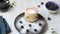 Topping powdered sugar Soft Japanese pancakes with blueberries on a round white plate. Light cotton napkin on a
