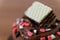 Toppings of chocolate cupcake with wafer and rainbow sugar stone