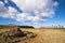 A toppled moai near the moais stone platform of Ahu Tongariki on the south coast of Easter Island. Easter Island, Chile