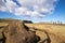 A toppled moai near the moais stone platform of Ahu Tongariki on the south coast of Easter Island. Easter Island, Chile