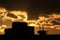 Tops of buildings silhouette in the glow of sunset