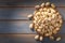 Topviewroasted salted pistachios arranged on wooden surface