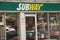 tor, canada - July 22, 2023: subway sandwiches store restaurant front entrance with logo above, neon open. p