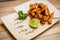 Tori kawa no karaage - japanese style deep fried chicken skin with salt and lime on wooden background , stock photo
