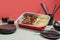 TORI TERIYAKI food tray with drinks and chopsticks isolated on grey background side view