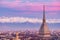 Torino Turin, Italy: cityscape at sunrise with details of the Mole Antonelliana towering over the city. Scenic colorful light on