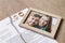 Torn divorce decree, rings and broken frame with photo on table