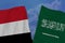 Torn fabric with beautiful silk national flag of Saudi Arabia, flag of yemen, close-up, copy space, travel concept, economy and