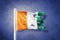 Torn flag of Cote d`Ivoire flying against grunge background