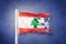 Torn flag of Lebanon flying against grunge background