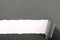 Torn gray paper strip white background curled edge horizontal