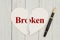 Torn heart-shape card on weathered wood background with text Bro