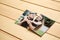 Torn photo of happy couple on wooden background. Concept of divorce