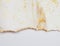 Torn piece of edge paper on white background. Gold and bronze color marble texture