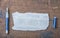 Torn piece of old paper for message or word of wisdom with pen on brown wood