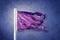 Torn Purple flag flying against grunge background