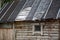 Torn ruberoid roofing material on the roof of the house