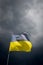 Torn Ukrainian flag on the background of a stormy