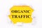 Torn white paper lies on a bright yellow background with the text ORGANIC TRAFFIC