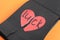 Torn word LUCK with heart written in notebook on orange background