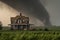 tornado barreling toward farmhouse, with stormchaser in pursuit