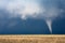 Tornado with dark clouds and stormy sky