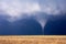 Tornado funnel cloud touching down.