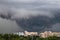 Tornado, funnel clouds during a thunderstorm a heavy rain downpour over the city.