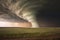 tornado funnel forming over flat prairie landscape