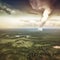 A tornado ripping through a landscape changed by climate changes