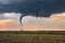 Tornado spins beneath a supercell thunderstorm