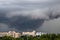 Tornado, thunderstorm, funnel clouds over the city.