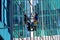 TORONTO, CANADA - 06 16 2016: Industrial climber cleaning the glassy wall of Canadian Broadcasting Centre building in