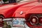 TORONTO, CANADA - 08 18 2018: Thunderbird logo with tail lights, chrome bumper and side decorations of red 1960 Ford