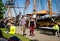 Toronto, Ontario, Canada - 2019 06 30: A couple walking in front of classic tall ships in the cheerful Harbourfront