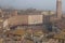 Torre del Mangia in Piazza del Campo and tupical ref roofs of Siena in the thick fog. Tuscany, Italy.