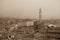 Torre del Mangia in Piazza del Campo and tupical ref roofs of Siena in the thick fog. Tuscany, Italy. Old polar effect.