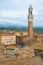 Torre del Mangia tower over the roofs of Siena, Italy