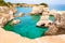 Torre Sant Andrea beach with its soft calcareous rocks and cliffs, sea stacks, small coves and the jagged coast landscape. Crystal