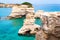 Torre Sant Andrea beach with its soft calcareous rocks and cliffs, sea stacks, small coves and the jagged coast landscape. Crystal