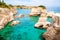 Torre Sant Andrea beach with its soft calcareous rocks and cliffs, sea stacks, small coves and the jagged coast landscape. Crystal