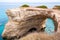 Torre Sant Andrea beach with its soft calcareous rocks and cliffs, sea stacks, small coves and the jagged coast landscape. Crystal