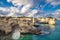 Torre Sant\\\'Andrea - Fissures and tunnels are formed, and bridges collapse leaving lonely sentinels rising above the waves