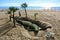 TORREMOLINOS, SPAIN - FEBRUARY 13, 2014: A man constructing a big sand sculpture of a crocodile at the beginning of tourist season