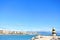 TORREMOLINOS, SPAIN - FEBRUARY 13, 2014: A view to Mediterranean sea, a lighthouse with breakwaters and Torremolinos at the backgr