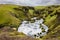 Torrent in the middle of a meadow in iceland with a sheep