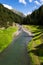 Torrente vallaccia flows into lake Lago di Livigno reservoir, Italy