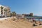 Torrevieja Spain with tourists and visitors on Playa Cura beach in the October sun