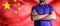 Torso of a man Young man with arms crossed against China states national flag