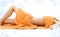 Torso of relaxed lady with orange towels